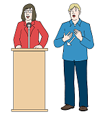 Zwei Personen stehen nebeneinander. Eine Frau und ein Mann. Die Frau spricht ins Mikrofon. Der Herr hat seine Hände vor dem Bauch und gebärdet.
